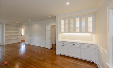 Living room has built-in bookshelves and Butler's 