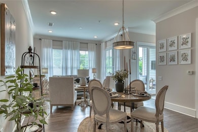Dining space with dark hardwood / wood-style floors and ornamental molding
