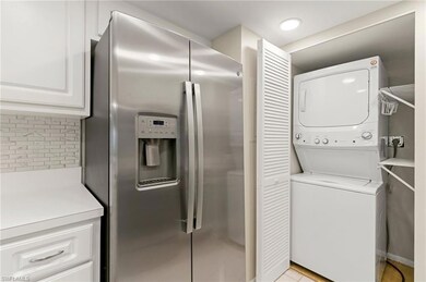 Washroom with stacked washing machine and dryer