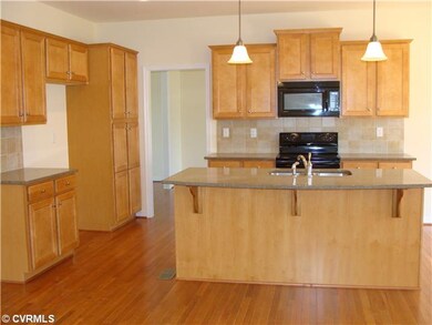 Kitchen - Hdwd kitchen featuring granite island an