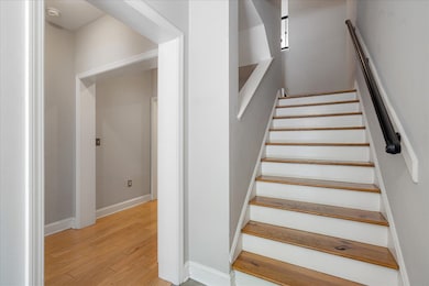Stairway featuring baseboards and wood finished fl