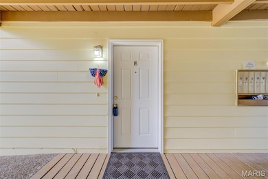 Doorway to property featuring a wooden deck