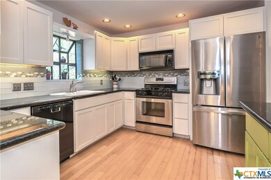 Gourmet center Island kitchen with rich hardwoods