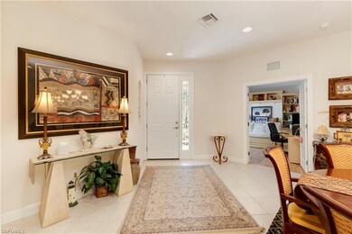 Entryway with light tile patterned floors, baseboa