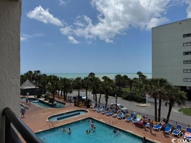 Community pool featuring a community hot tub and a patio