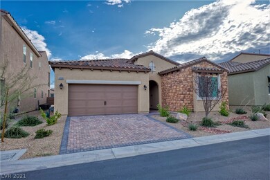 Front of the house with stone paved driveway.