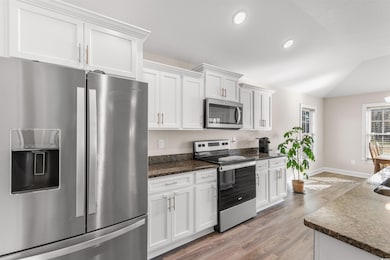 Kitchen with light wood finished floors, baseboard