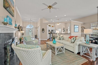 Living room with baseboards, a tile fireplace, orn