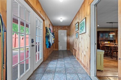 Mud room with entrance from brick patio and garage
