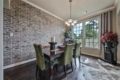 The stunning brick wall is the focal point of this beautiful dining room.