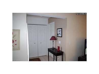 Entry hall with tile floor and access to half bath