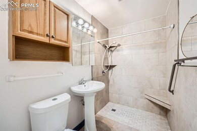Full bath with a stall shower, a sink, and toilet