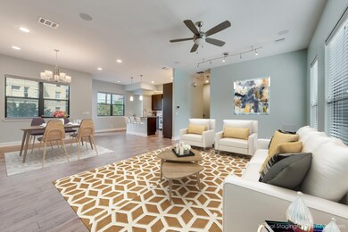 Living room featuring light wood-type flooring, a ceiling fan, a chandelier, and recessed lighting
