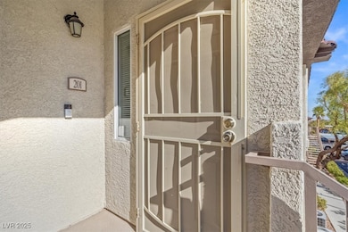 Doorway to property with stucco siding and a balco