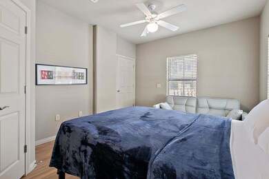 Bedroom featuring light wood-type flooring, a cei
