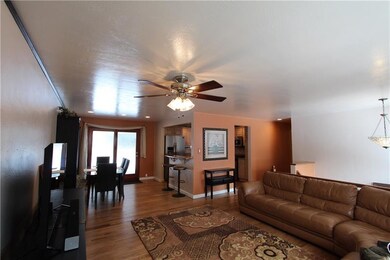 The dining area is open to the kitchen with a bar 