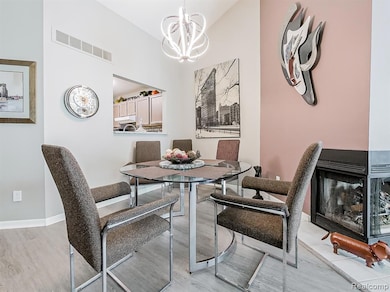 Dining area featuring a chandelier and light wood-type flooring