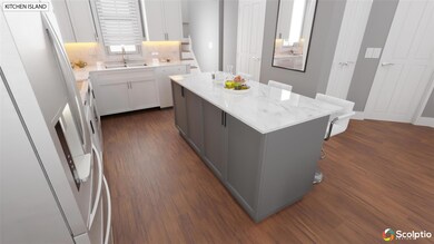 Kitchen featuring a kitchen island, dark wood fin