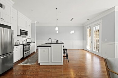 Spacious and modern kitchen with white cabinetry,