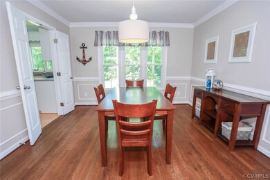 Formal Dining Room with elegant molding, hardwood