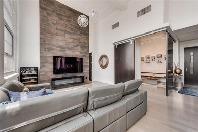 Living room with wood-type flooring, a towering ce