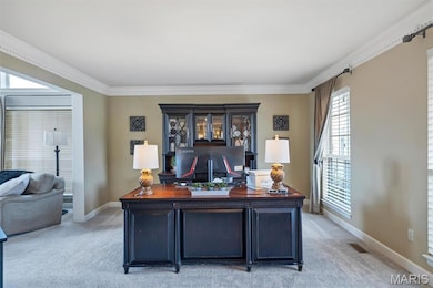 Office space with light colored carpet and crown molding