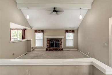 Alternate angle of the family room showcasing open sightlines to the dining area, overhead lighting, and clean architectural details.