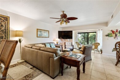 Living area featuring a ceiling fan, baseboards, a