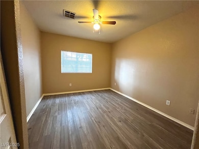 Spare room with dark wood-style flooring, ceiling