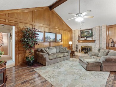 Large living area with a cozy brick, wood-burning 