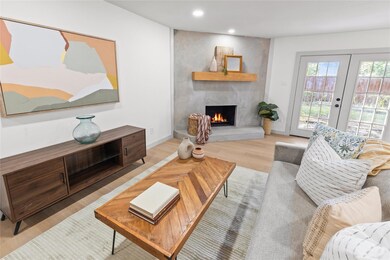 Living room featuring french doors, light hardwood