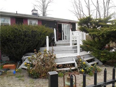 Exterior Back. Deck in back comes down to patio th