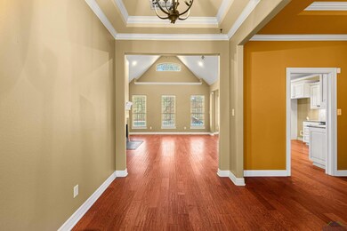 Corridor featuring lofted ceiling, hardwood / wood