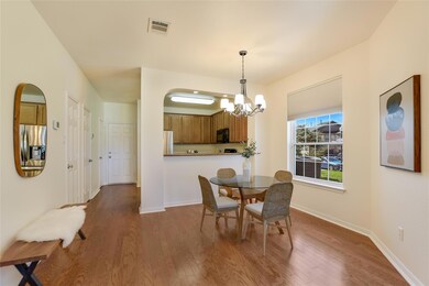 Dining space with a chandelier, wood finished flo