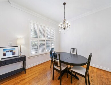 Large windows with plantation shutters fills this