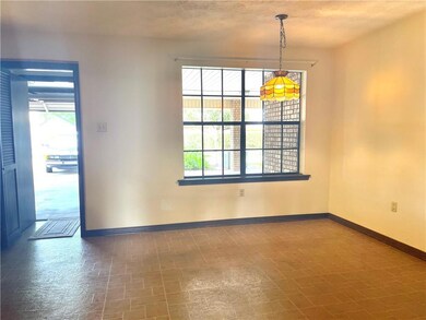 Dining looking onto covered patio and garage.