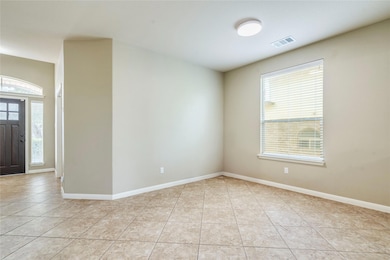 Unfurnished room featuring light tile patterned f