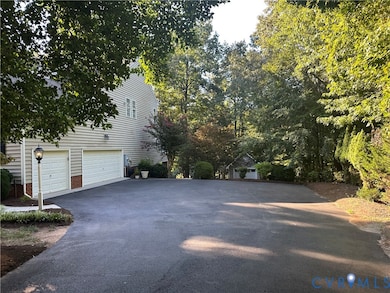Long paved driveway is very wide as you approach the garage