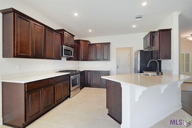 Stunning kitchen with espresso cabinetry, marble c