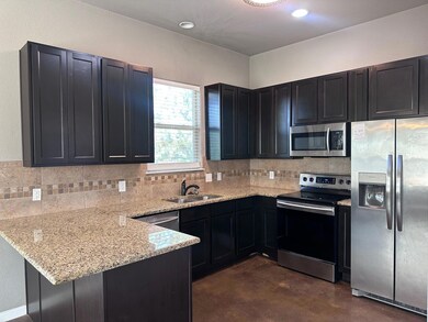 Kitchen with stainless steel appliances, a penins