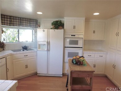 Lower unit kitchen with wood flooring and lot of c