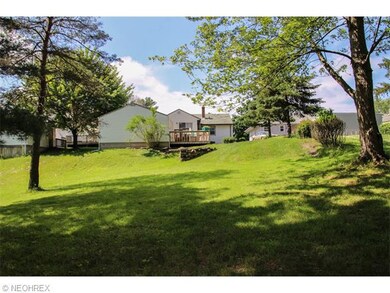 View of the back and home and garage from the back