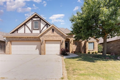 English style home with a shingled roof, concrete driveway, brick siding, a front yard, and a garage