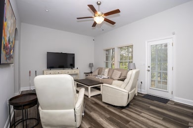 Living area featuring baseboards, wood finished fl
