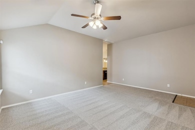 Living room with vaulted ceiling and fan