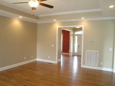 Other Living Room Features include 10' Ceilings, Trey Ceiling, Ceiling Fan, & a Warm Neutral Tone