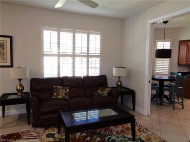 Tiled living room featuring ceiling fan