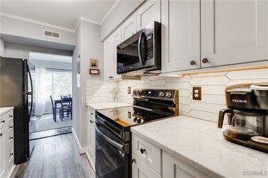 Kitchen featuring stainless steel appliances, back