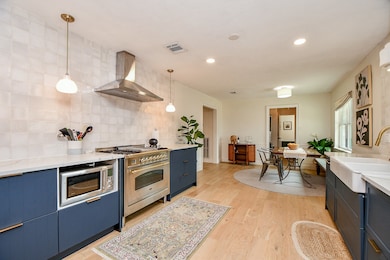 This spacious kitchen features modern blue cabinet