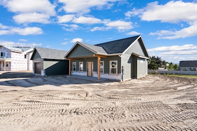 View of front of house with an attached garage and driveway